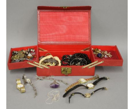 A red leather jewellery box, containing a collection of ladies wristwatches, a silver pendant on a chain marked 925, an ivory