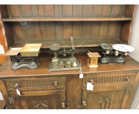 A set of late 19th century cast iron and brass scales, with rectangular brass pans, two further sets of cast iron scales, and