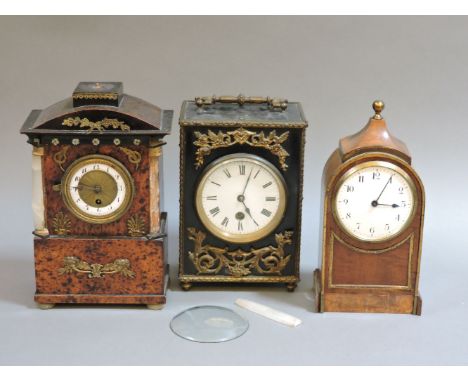 A 19th century French ebonised mantel clock, with gilt metal mounts and drum movement, 26cm high to handle, another in a maho