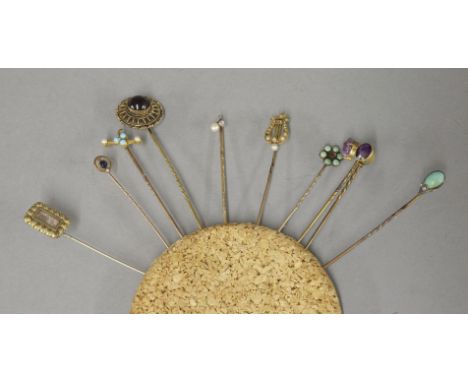 Ten assorted Victorian and later stick pins, including a sapphire and split seed pearl example stamped 9ct, a Victorian Etrus