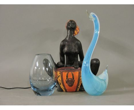 A Vallauris table lamp, modelled as an African lady playing a drum, a Holmegaard glass vase, and a Murano ornament