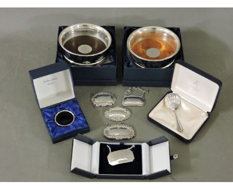 Silver items, two modern coasters, five wine labels, a bottle drip ring, and a caddy spoon