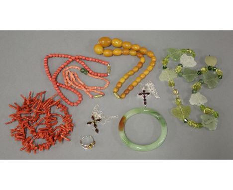 A twig coral necklace, a glass bangle, a hardstone butterfly necklace, a reconstituted coral necklace, and assorted jewellery
