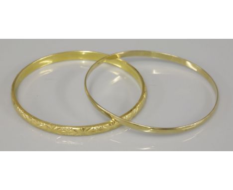 A 9ct gold bangle, and a hollow diamond cut bangle, tested as approximately 18ct gold