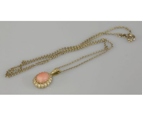 An 18ct gold coral and diamond oval cluster pendant, on a 9ct gold chain