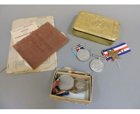 A Queen Mary tin containing WW1 and WW11 service medals, awarded to Sgt JH Morley, R SUSS R, together with soldier's pay book