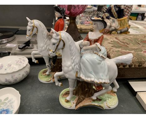TWO CERAMIC FIGURES OF A MAN AND LADY OUT RIDING HEIGHT 21CM 
