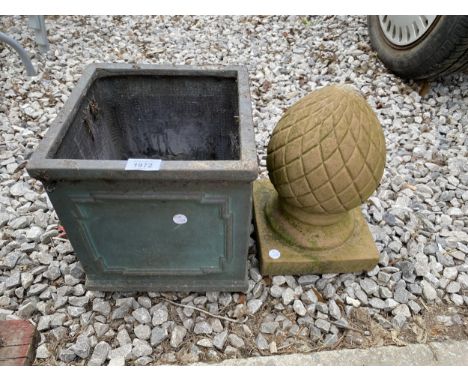 AN ACORN FINIAL AND A CEMENT FIBRE PLANTER 