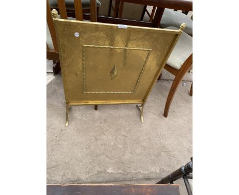 AN EDWARDIAN BRASS FIRESCREEN 