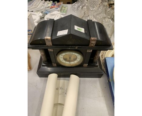 A VINTAGE BLACK MARBLE MANTLE CLOCK WITH PILLAR DECORATION VENDOR STATES IN WORKING ORDER BUT NO WARRANTY GIVEN 