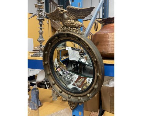 A VINTAGE GILT CIRCULAR STUDDED ASTONEA MIRROR WITH EAGLE DESIGN TOP 