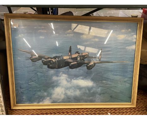 A LARGE FRAMED PRINT OF AN AVRO LANCASTER BOMBER 