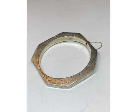 A SILVER ORNATE BANGLE 