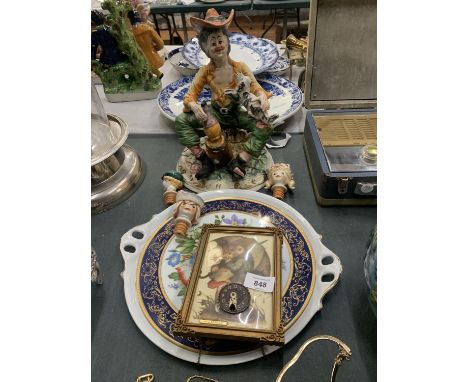 A HUMMEL WALL CLOCK, A CAPODEMONTE FIGURE, NOVELTY BOTTLE STOPPERS AND A LARGE CHARGER 