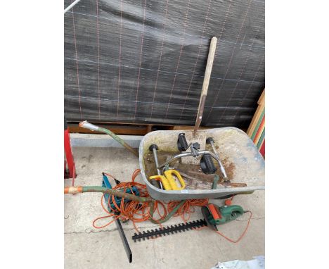 AN ASSORTMENT OF TOOLS TO INCLUDE A WHEEL BARROW, A SPADE AND A SAW ETC 