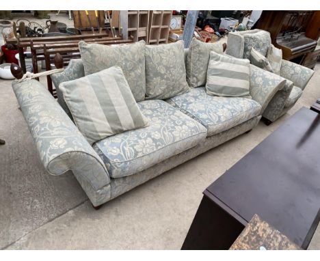 A MODERN KNOLE SOFA ON TURNED LEGS AND A MATCHING EASY CHAIR 