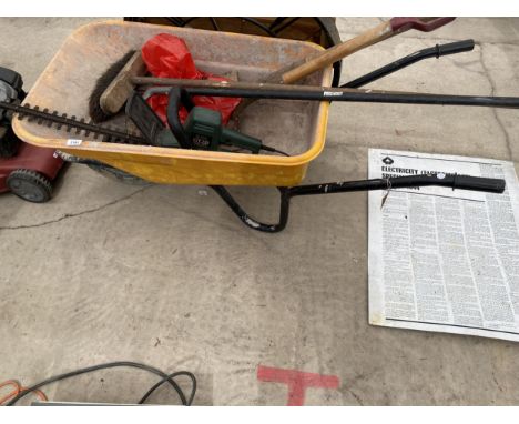 AN ASSORTMENT OF TOOLS TO INCLUDE A PLASTIC WHEEL BARROW, AN ELECTRIC HEDGE TRIMMER AND A SHOVEL ETC 