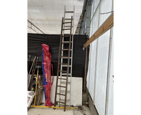 A TWELVE RUNG WOODEN LADDER AND AN ALUMINIUM 24 RUNG TWO SECTION EXTENDING LADDER 