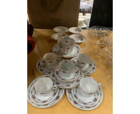 AN ENGLISH CHINA TEASET WITH A FLORAL PATTERN TO INCLUDE CUPS, SAUCERS, SIDE PLATES, BOWLS, A CAKE PLATE CREAM JUG AND SUGAR 