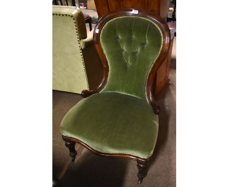A Victorian button upholstered spoon back nursing chair, on turned legs, height 92cm