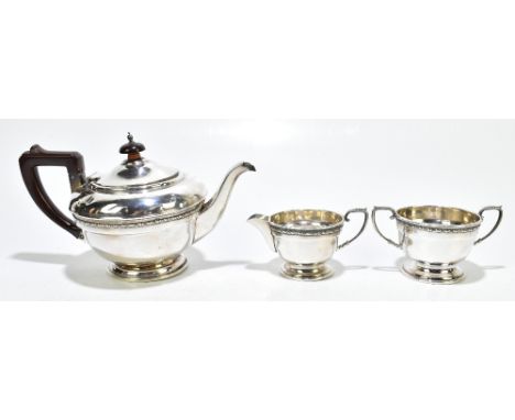 A George V hallmarked silver three piece tea service with bakelite handle and finial to the teapot, Birmingham 1932, length 2