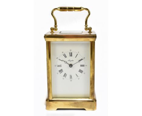 A modern brass carriage clock signed Angelus to the dial, the dial with both Arabic and Roman numerals, height including swin