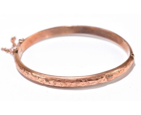 A 9ct rose gold hinged snap bangle, approx 7.5g, (af).Additional InformationSome heavy dents to the frame, slightly misshapen
