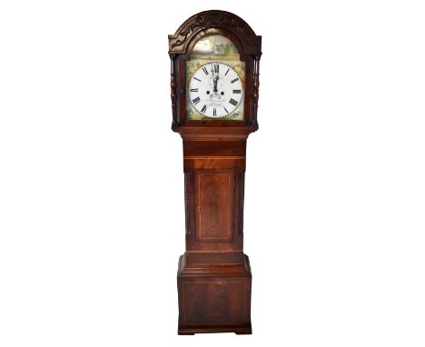 A mid 19th century mahogany and boxwood strung longcase clock, the carved pediment above arched painted dial set with Roman n