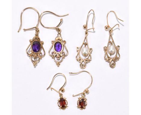 A pair of yellow metal and amethyst earrings, with a pair of garnet set earrings and a pair of pearl earrings (6).Additional 