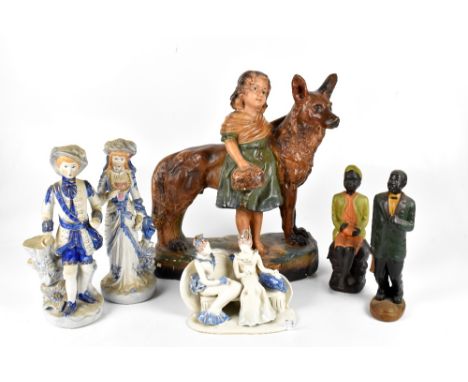 A painted plaster figure of a girl standing beside a German shepherd, height 39cm, with two pottery figures and two Continent
