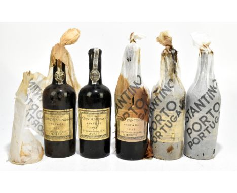 Five bottles of vintage 1958 Constantino's Port, four retaining paper wrappers and two with straw protectors, in an opened ca