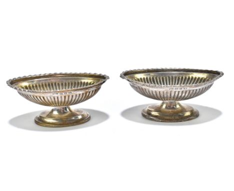 A pair of late Victorian hallmarked silver oval pedestal dishes, with fluted detailing, Birmingham 1899, length 8.25cm.Additi