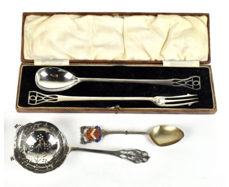 COOPER BROTHERS & SONS; a cased George V Modernist hallmarked silver spoon and pickle fork with pierced handles and elongated