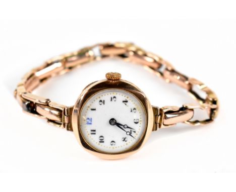 A lady's 9ct gold wristwatch, the white enamel dial with Arabic numerals, with 9ct flexi-link bracelet, gross weight 22g.Addi