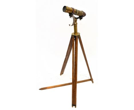 An unnamed brass three draw telescope on associated brass mounted tripod stand, length of telescope when closed 25cm, height 