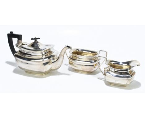 JONES &amp; CROMPTON; an Edward VII hallmarked silver three piece tea service of square form with panelled bodies, each with 