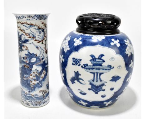 A late 19th century blue and white ginger jar with associated carved wooden cover, with three panels decorated with objects i