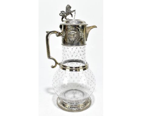 A Victorian star decorated clear glass and silver plate mounted claret jug, the hinged lid surmounted with a lion and shield 