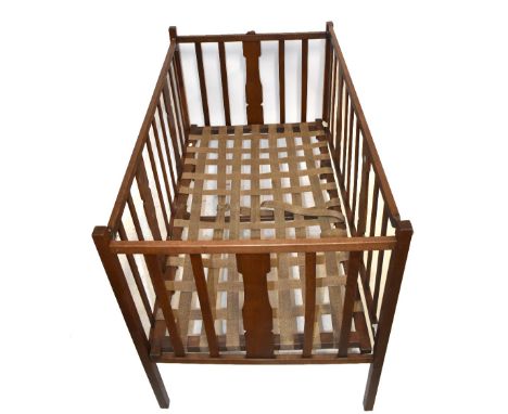 ROBERT 'MOUSEMAN' THOMPSON; an oak cot with base and with signature mouse, width 85cm.