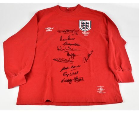 ENGLAND 1966 WORLD CUP WINNERS; an Umbro England retro style home shirt, signed by Peters, Hurst, J. Charlton, Wilson, Stiles