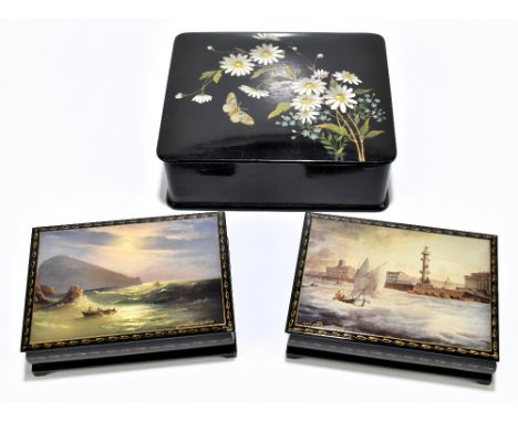 Two modern Russian lacquered&nbsp;papier-mâché boxes, each depicting sailing scenes and each signed, with red interiors width