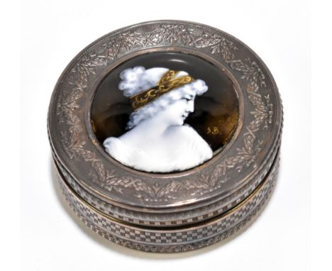 LIMOGES; a French silver circular box, the cover set with an enamelled plaque painted with the profile portrait of a young wo