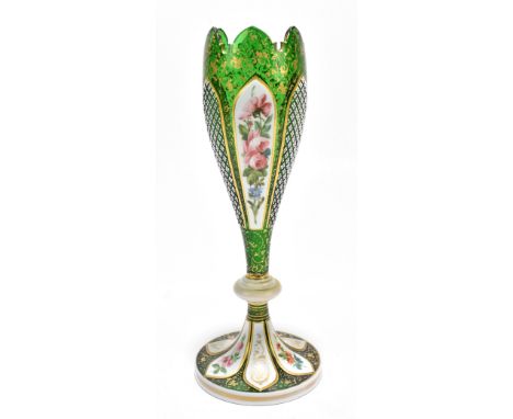 A late 19th century Bohemian green glass floral painted gilt heightened and white enamel decorated vase, height 29.5cm.Additi