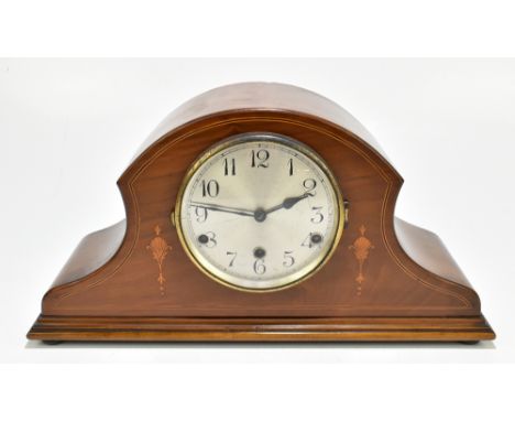 An Edwardian mahogany and inlaid chiming mantel clock with circular silver dial set with Arabic numerals, width 49cm.Addition