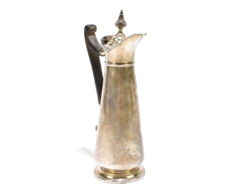 An early 20th century hallmarked silver ewer of small proportions, the hinged lid with high scroll wooden handle tapering mai