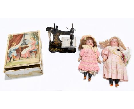 Two bisque headed dolls including a German example with celluloid articulated limbs, height 18cm, also a boxed vintage child'