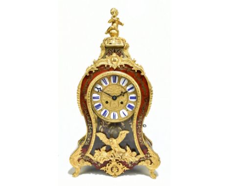 A French tortoiseshell and brass inlaid bracket clock with cherub finial above circular dial set with Roman numerals to the w