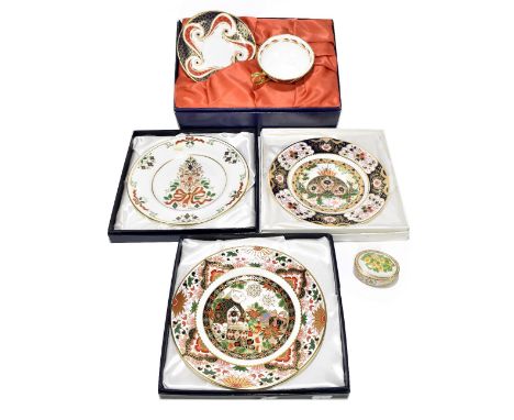 ROYAL CROWN DERBY; three boxed limited edition Christmas plates, including 1997 and 2000, also with boxed teacup and saucer a