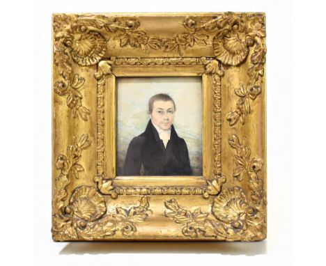 An early 19th century watercolour, three-quarter portrait miniature of a gentleman wearing a black overcoat, indistinctly mon