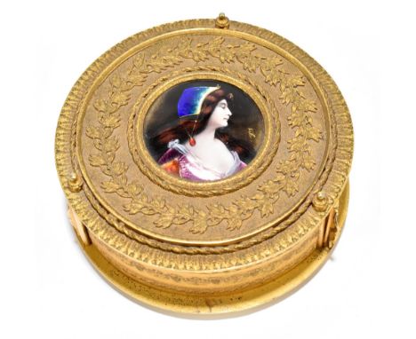 LIMOGES; a gilt metal circular trinket box with the unusual feature of three velvet lined pin hinged compartments to the body